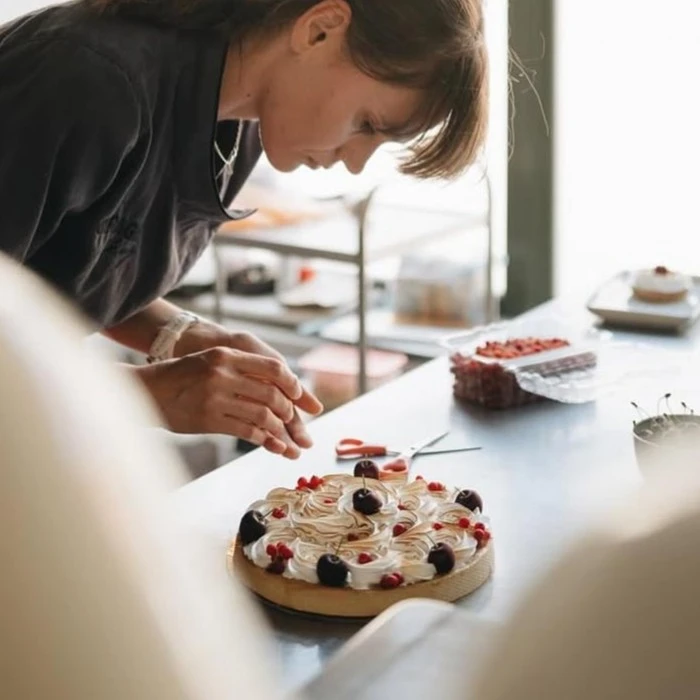 Lady decorating a cake
